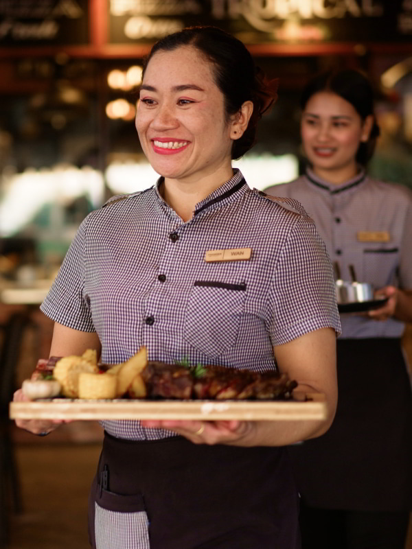 Waitress serving steak
