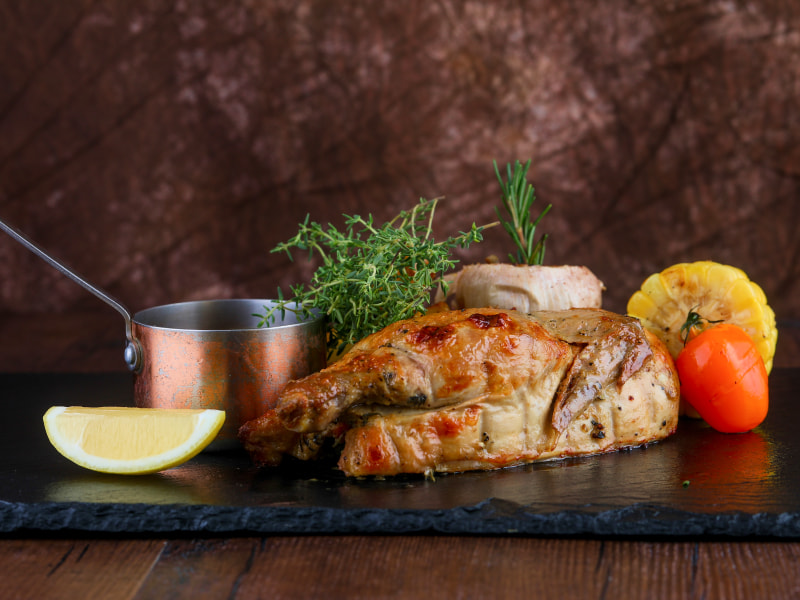 Grilled meat with lemon corn tomato herb and sauce