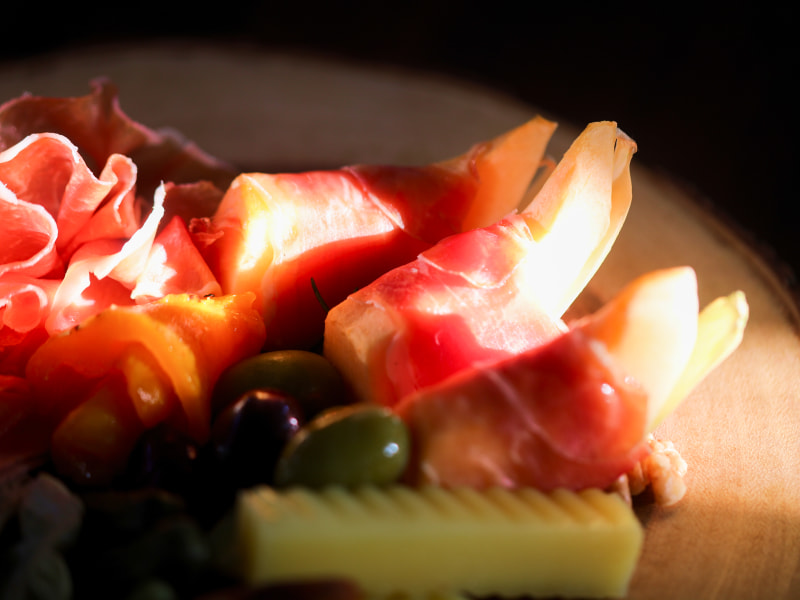 Blurry cold cuts with dark background and sun ray