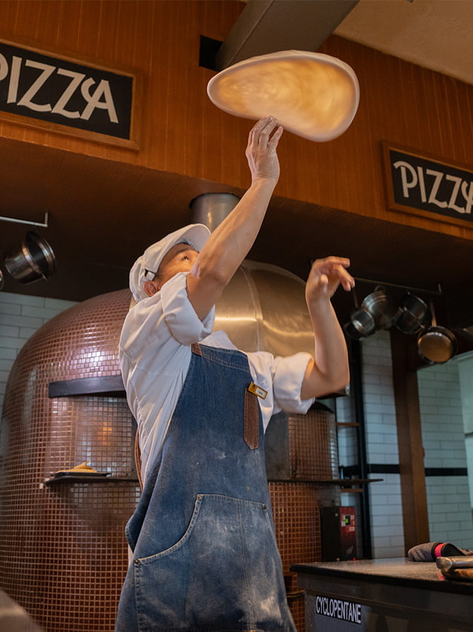 Authentic Neapolitan-style pizza being prepared at a beachfront restaurant in Phuket