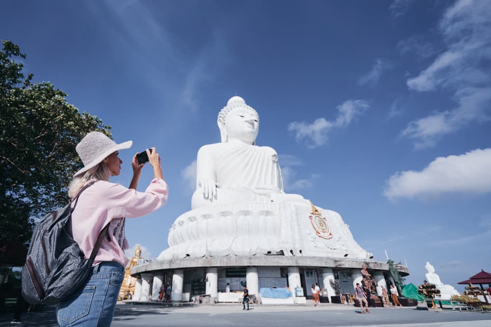 A Woman Taking A Photo Of The Big Buddha In Karon Phuket