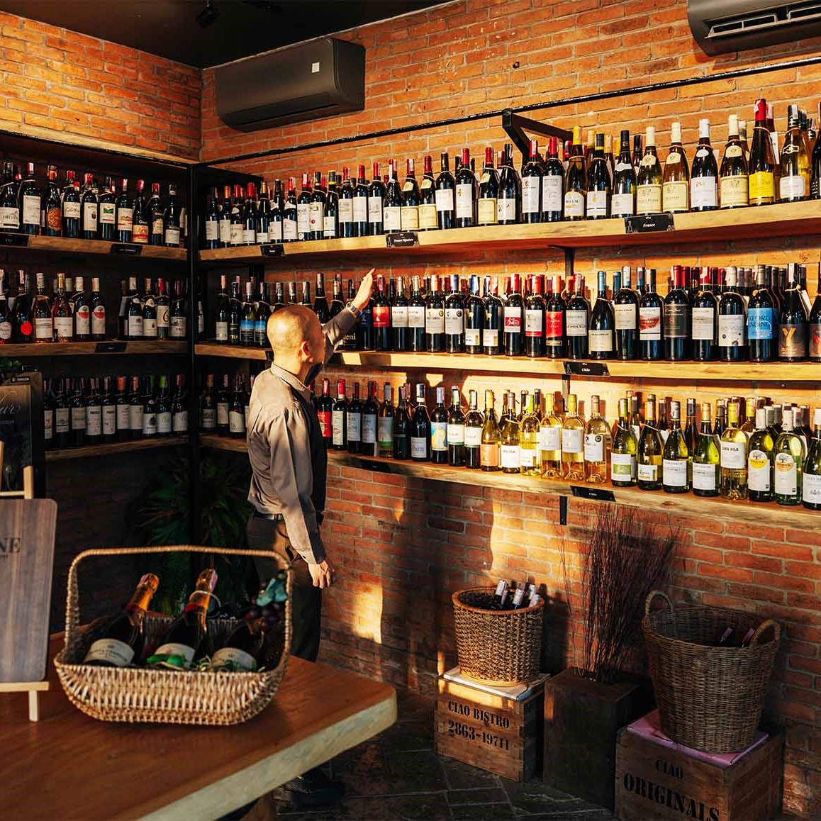 A Person In Front Of Wine Shelf