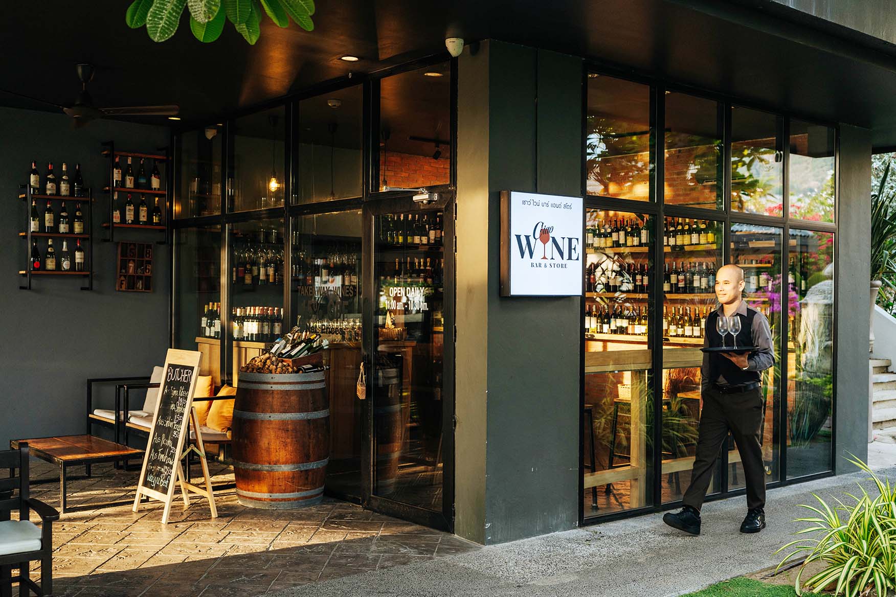 A Waiter Carrying A Tray With Wine Glass